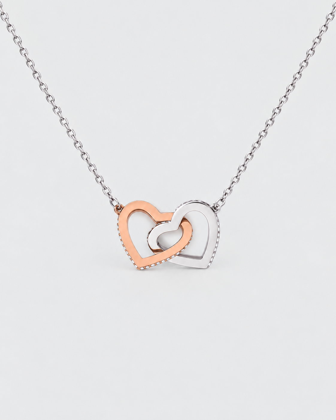 Connected Hearts necklace in silver-tone on a light grey background