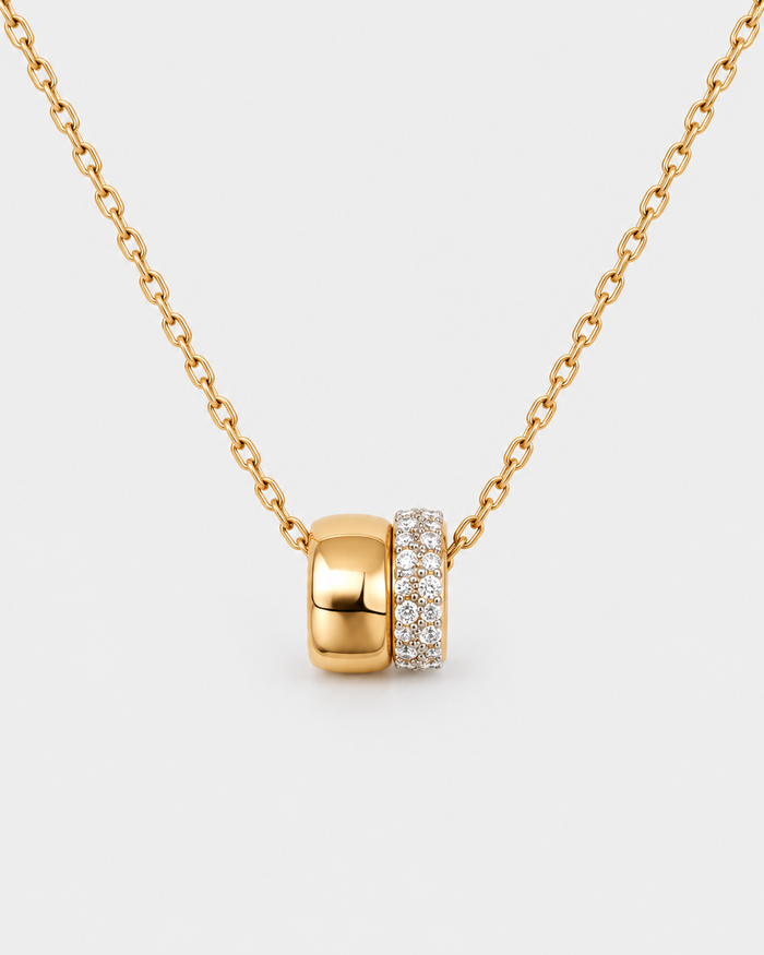 Eternal Rings necklace in gold-tone stainless steel on a light grey background