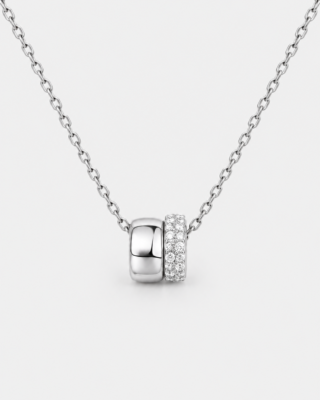 Eternal Rings necklace in silver-tone stainless steel on a light grey background