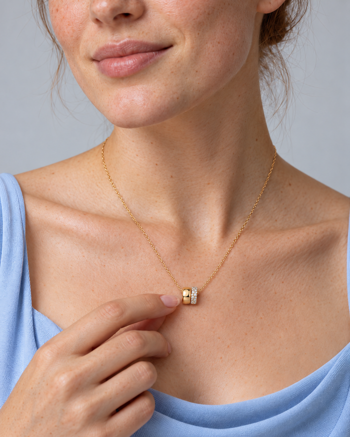 Woman wearing the Eternal Rings necklace, gold-tone finish