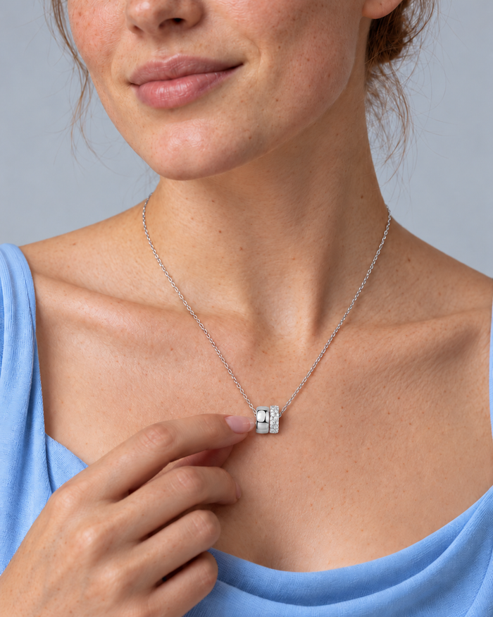 Woman wearing the Eternal Rings necklace, silver-tone finish