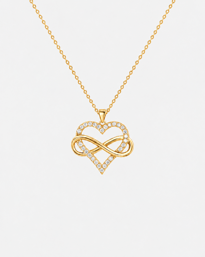 Infinity Heart necklace in gold-tone stainless steel on a light grey background