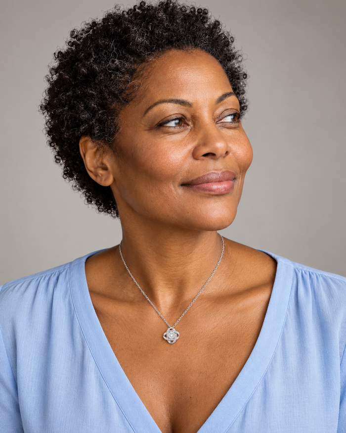 Woman wearing the Love Knot necklace, silver-tone finish