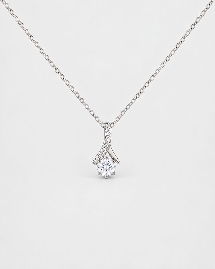 Love Pendant necklace in silver-tone stainless steel on a light grey background