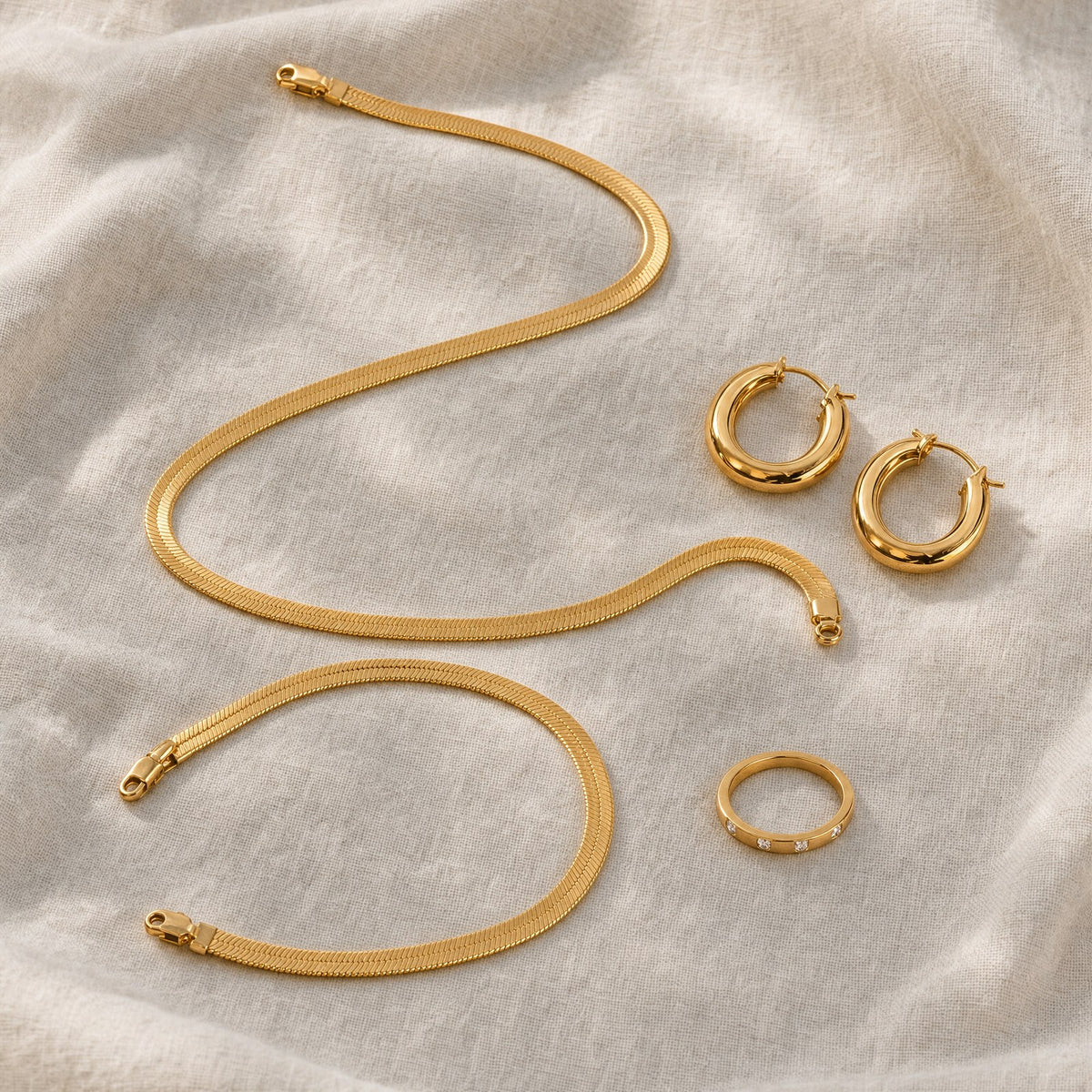 MAREA Tide Stack herringbone necklace, bracelet, hoops and ring flat lay