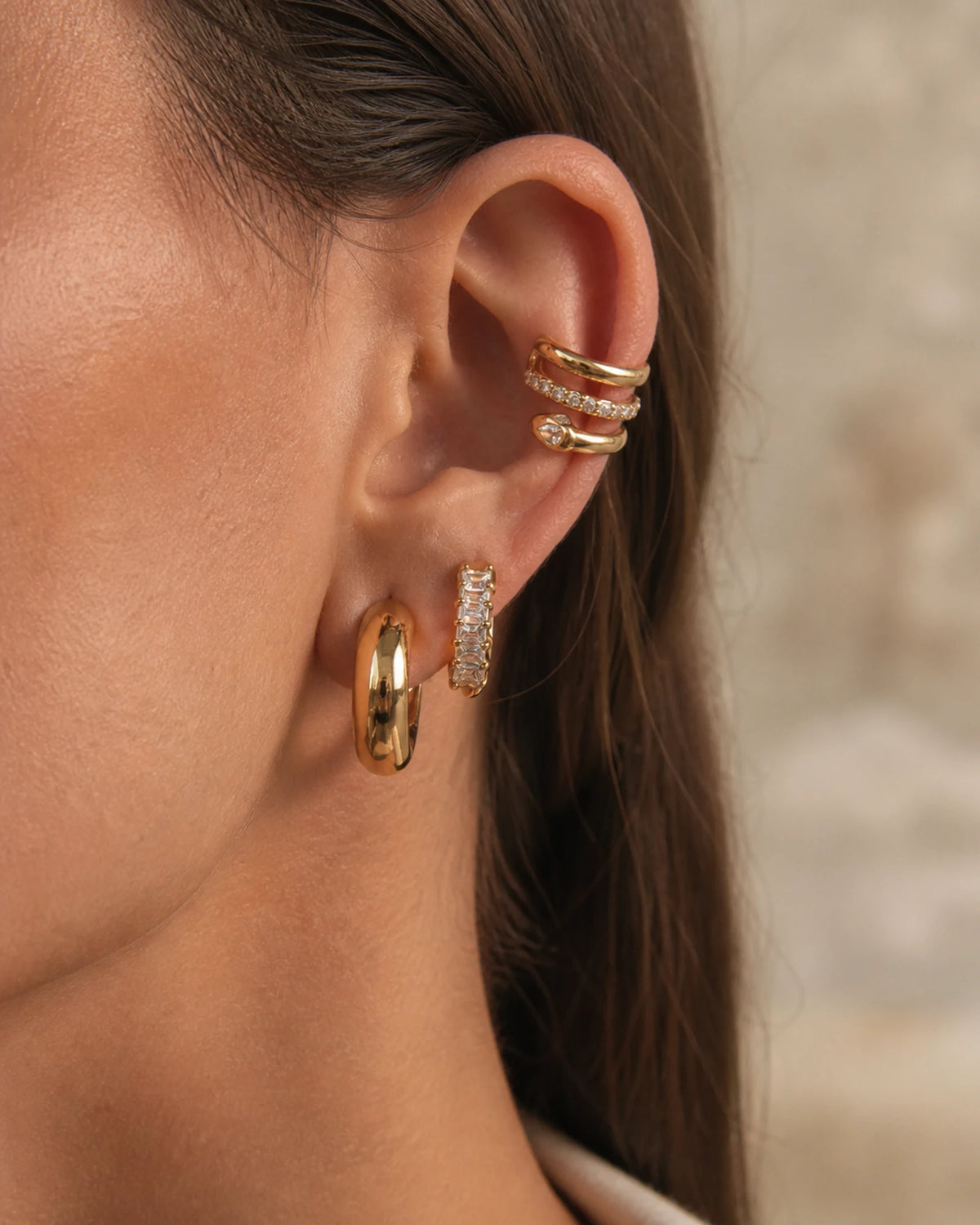 MAREA Horizon Stack styled on one ear - snake cuff, two pave huggies and a dome hoop