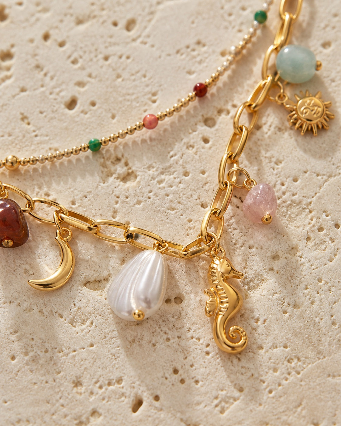 Woman wearing the MAREA Tidepool Necklace - enamel bead strand and gold seahorse charm chain