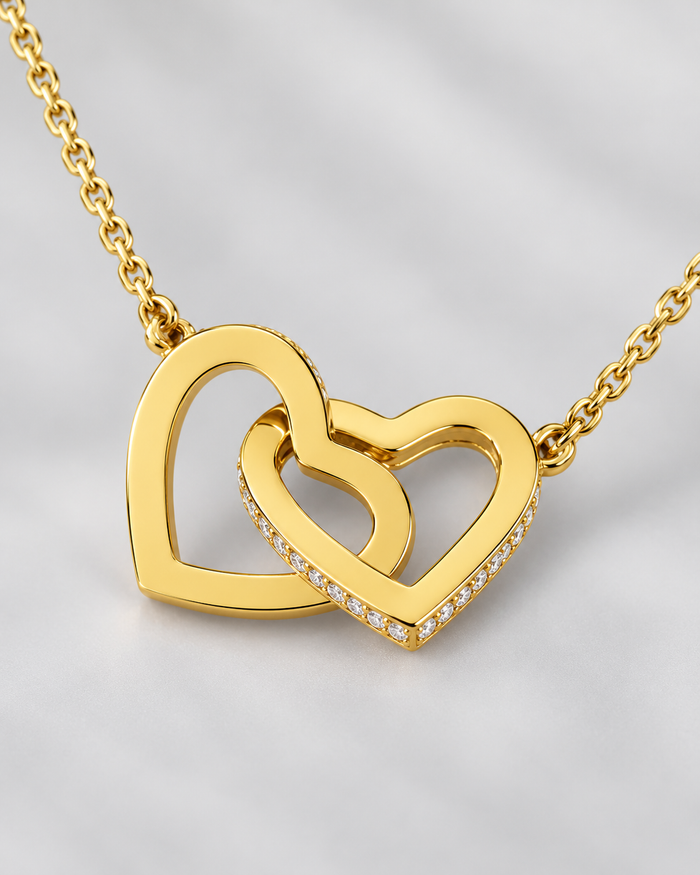 Close-up of the Connected Hearts necklace, gold-tone finish