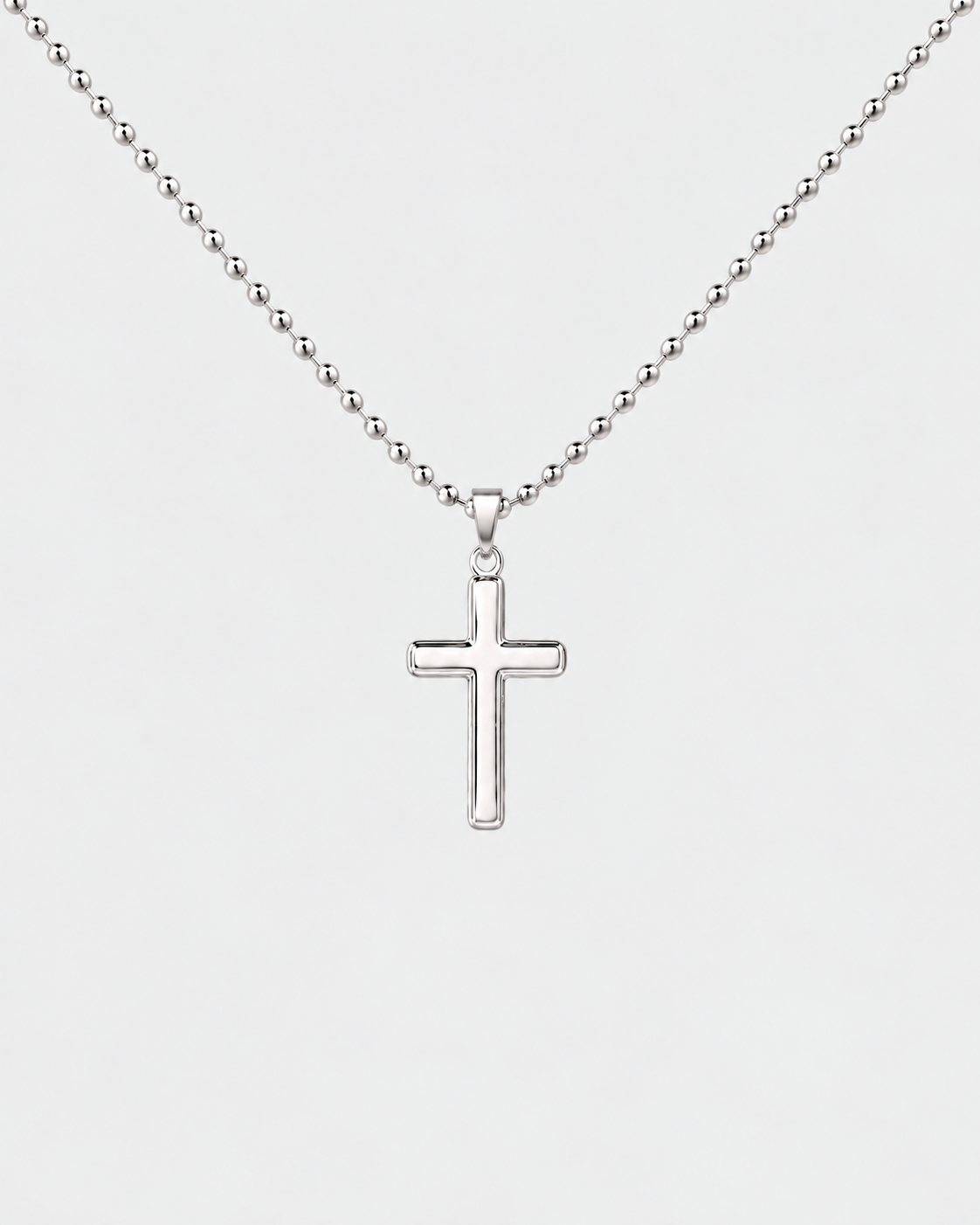 Cross necklace in silver-tone stainless steel on a light grey background