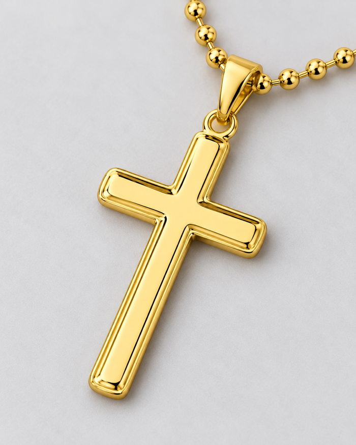 Close-up of the Cross necklace, gold-tone finish