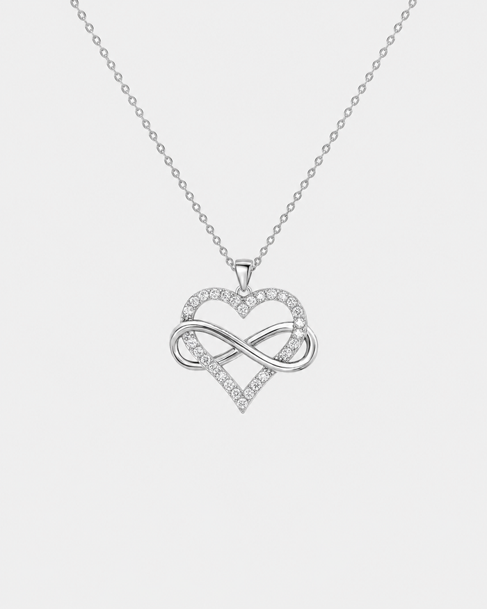 Infinity Heart necklace in silver-tone stainless steel on a light grey background