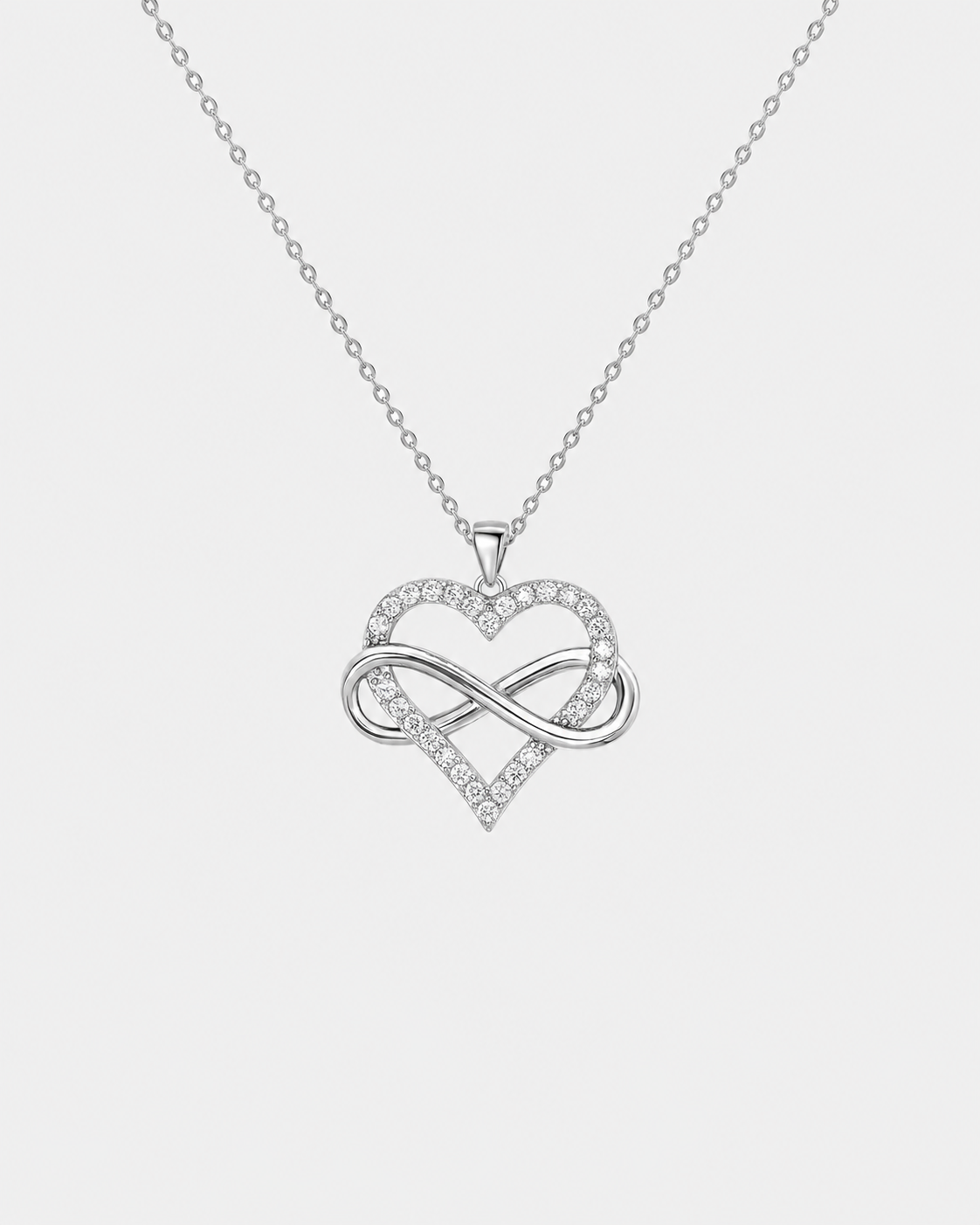 Infinity Heart necklace in silver-tone stainless steel on a light grey background