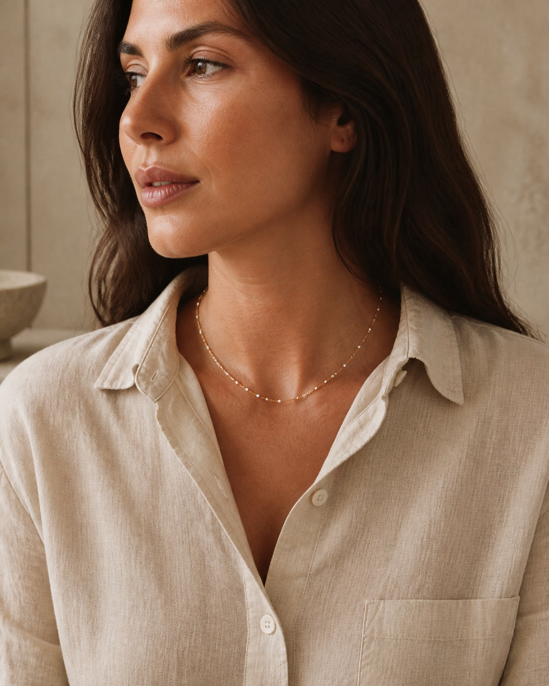 Woman wearing the gold MAREA Drift Choker at the throat